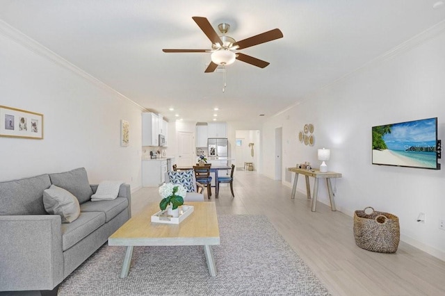 10998 Gable Dig Loop, San Antonio, FL 33576 - living room with light wood-style floors, ornamental molding, baseboards, and ceiling fan