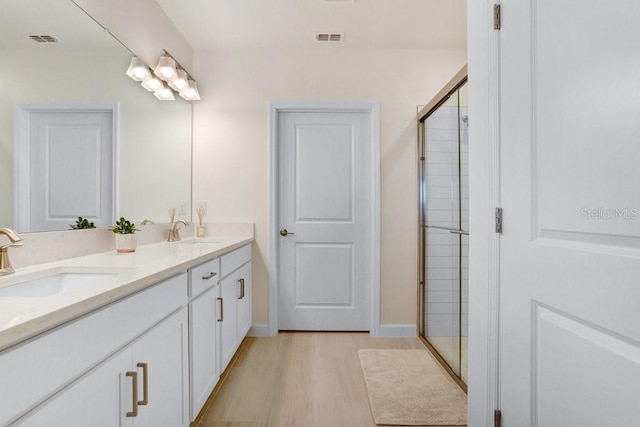 10998 Gable Dig Loop, San Antonio, FL 33576 - bathroom featuring visible vents, a sink, and wood finished floors