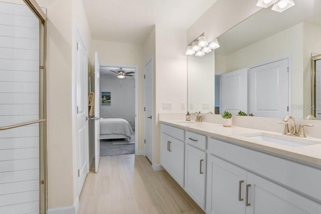 10998 Gable Dig Loop, San Antonio, FL 33576 - ensuite bathroom with double vanity, a sink, a shower with shower door, and ensuite bath