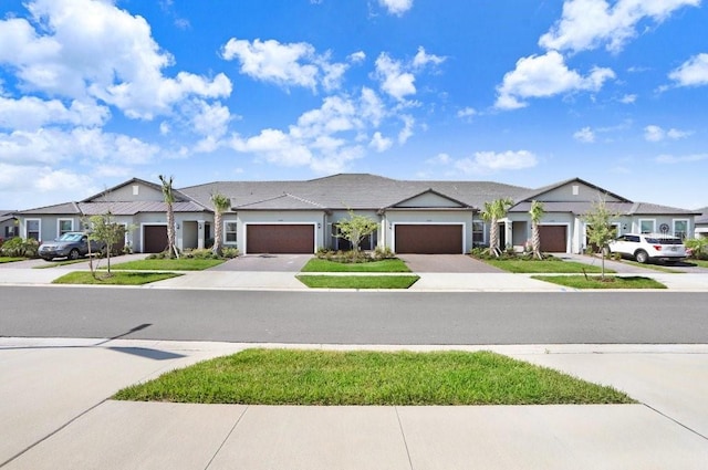 10998 Gable Dig Loop, San Antonio, FL 33576 - view of front of house featuring a residential view, an attached garage, and driveway