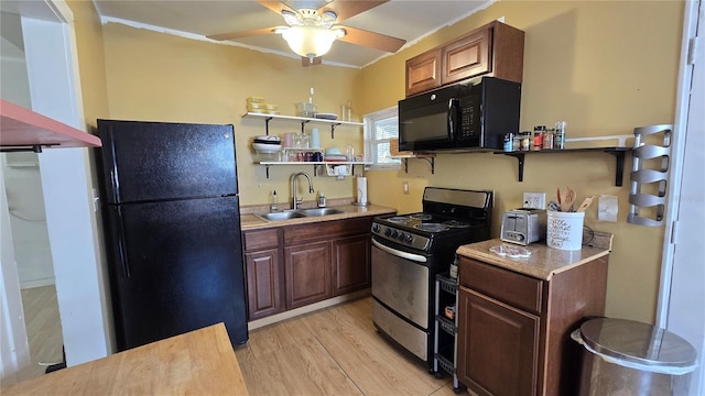 342 N 40th St N, Saint Petersburg, FL 33713 - kitchen with ceiling fan, open shelves, a sink, black appliances, and light wood-style floors