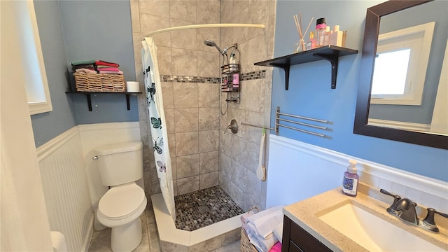 342 N 40th St N, Saint Petersburg, FL 33713 - full bath with vanity, toilet, a stall shower, and a wainscoted wall