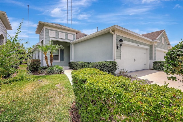traditional-style home featuring concrete driveway, stucco siding, a shingled roof, and a garage