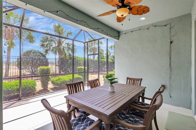 sunroom / solarium featuring outdoor dining area, ceiling fan, and a wealth of natural light