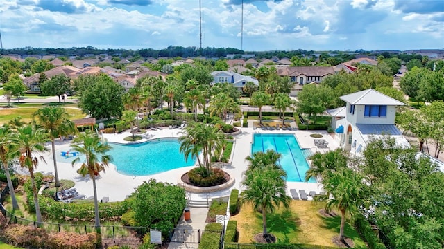 pool with a residential view, fence, and a patio area