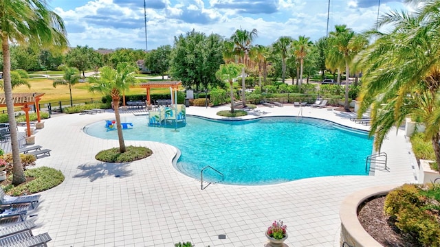 community pool with fence, a pergola, and a patio