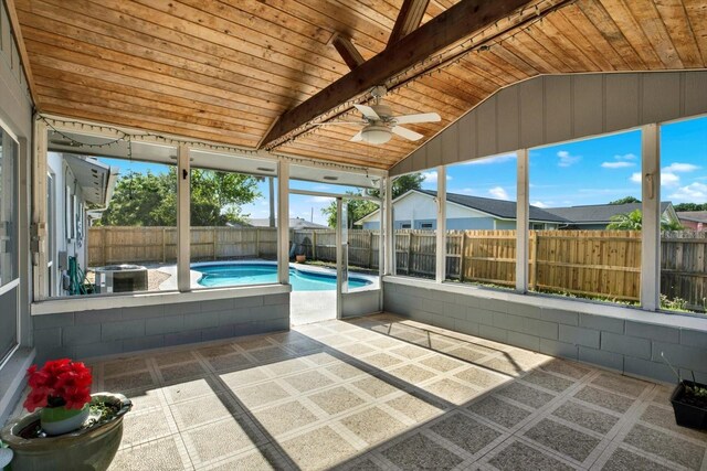 unfurnished sunroom featuring ceiling fan
