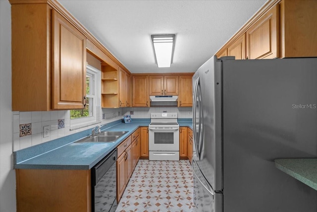 kitchen with electric range, a sink, freestanding refrigerator, under cabinet range hood, and black dishwasher