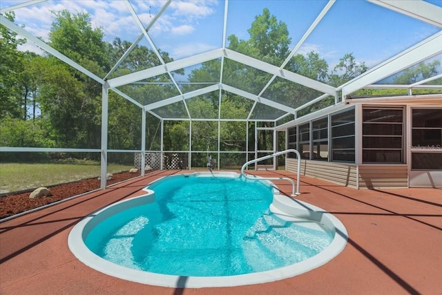 outdoor pool featuring a patio and glass enclosure