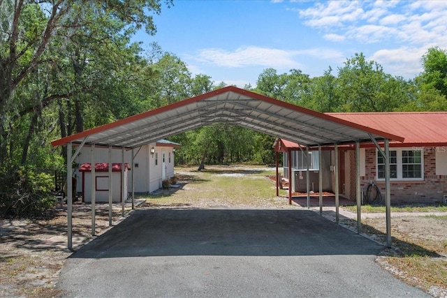 view of car parking with a carport and aphalt driveway