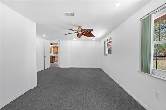 empty room featuring carpet floors, visible vents, baseboards, ceiling fan, and recessed lighting