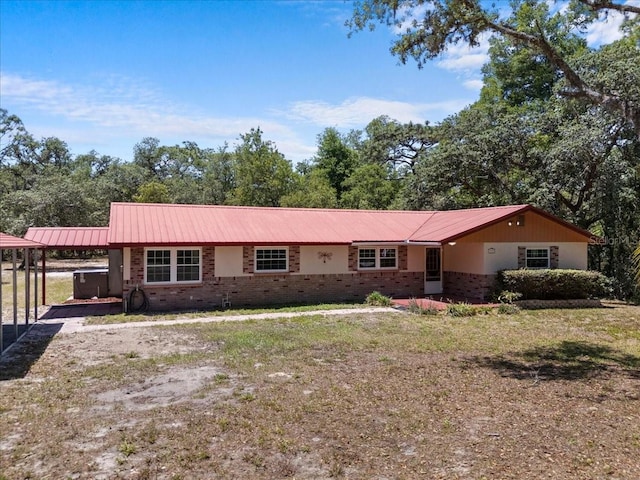 7095 S St, Webster, FL 33597 - single story home featuring brick siding, a carport, and metal roof