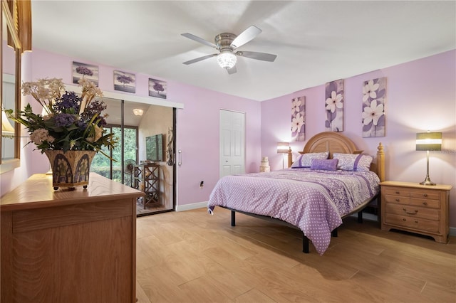bedroom featuring a ceiling fan, baseboards, multiple closets, and light wood-style floors