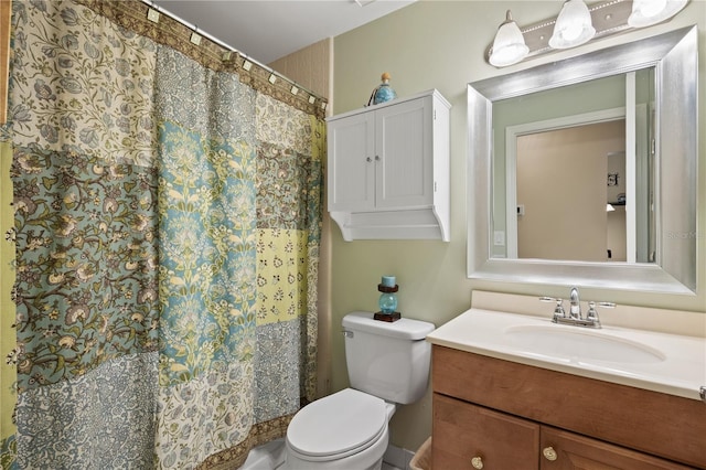 bathroom featuring vanity, a shower with shower curtain, and toilet