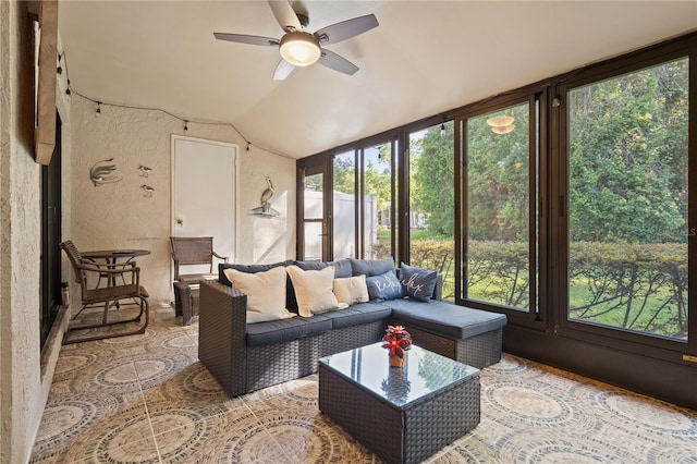 sunroom / solarium with a textured wall, ceiling fan, and a wealth of natural light