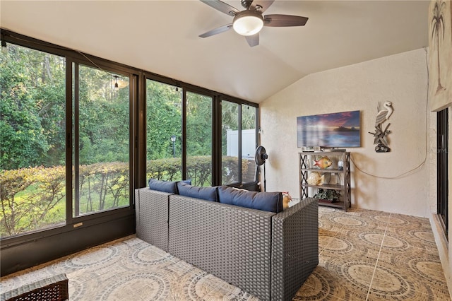 living room featuring plenty of natural light, a ceiling fan, a textured wall, and vaulted ceiling