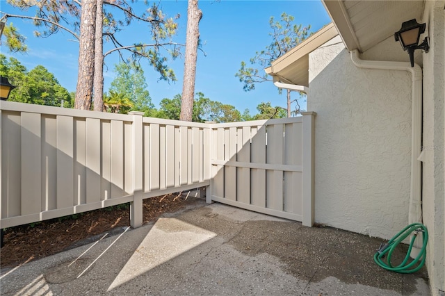 view of patio with fence and a gate