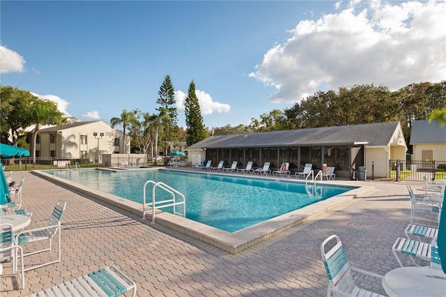 pool featuring fence and a patio area