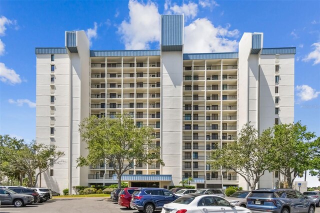 view of building exterior featuring uncovered parking