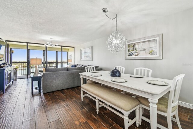 dining space featuring floor to ceiling windows, dark wood-style floors, a textured ceiling, and a chandelier