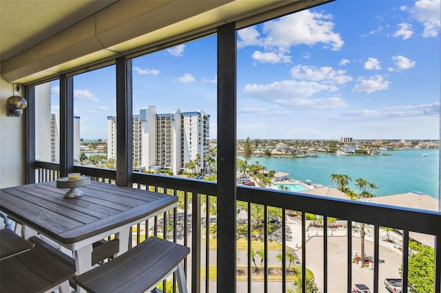 balcony with a water view and a city view
