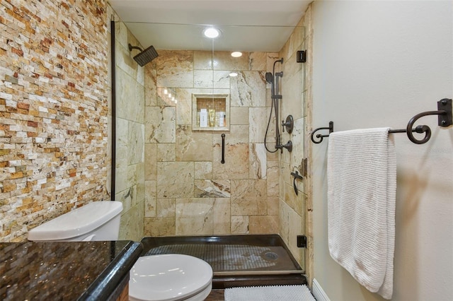 full bath featuring vanity, toilet, and a shower stall