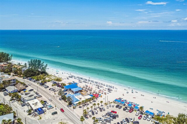 birds eye view of property with a water view and a view of the beach