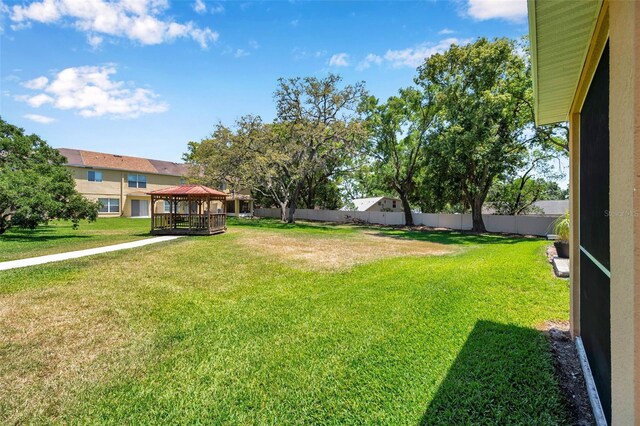 view of yard with a gazebo and fence