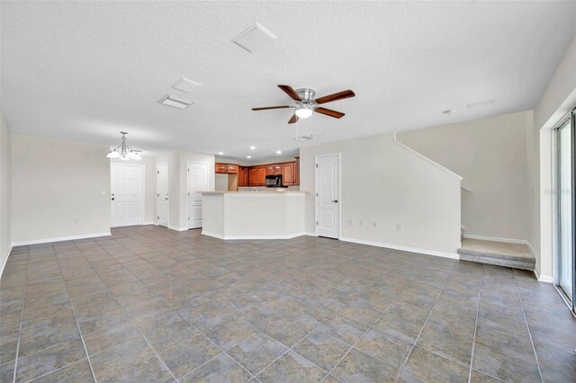 unfurnished living room with recessed lighting, a textured ceiling, baseboards, and ceiling fan with notable chandelier