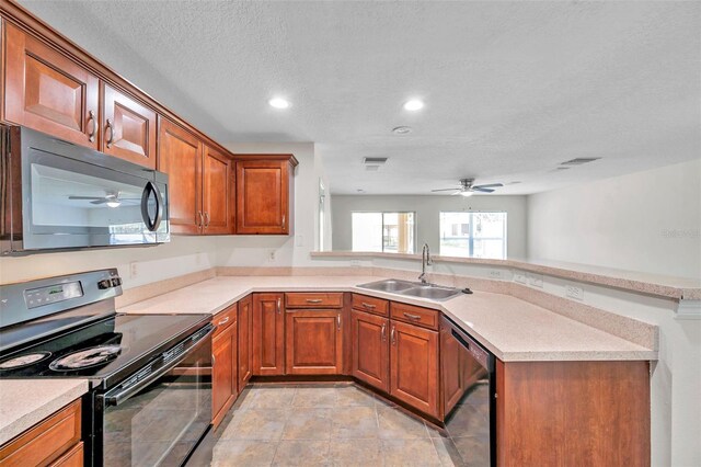 kitchen with brown cabinets, ceiling fan, a sink, and black appliances