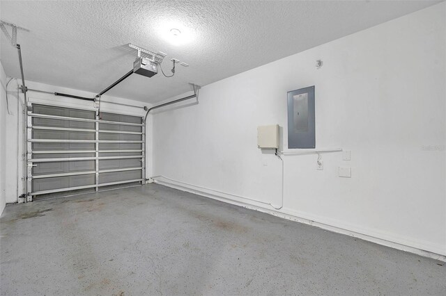 garage with a garage door opener and electric panel
