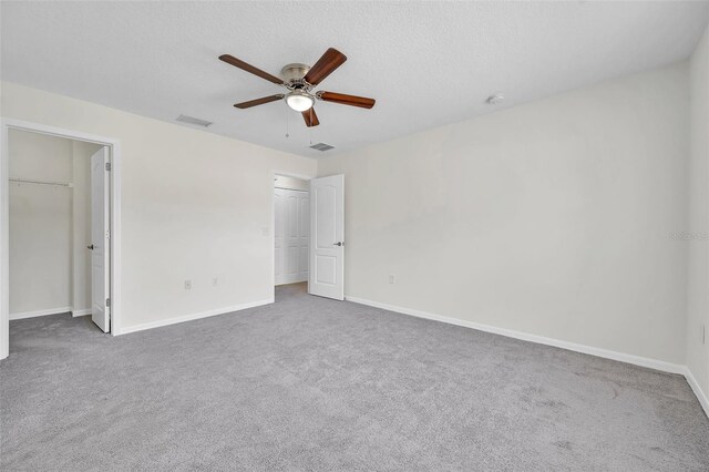 unfurnished bedroom featuring visible vents, carpet, and baseboards