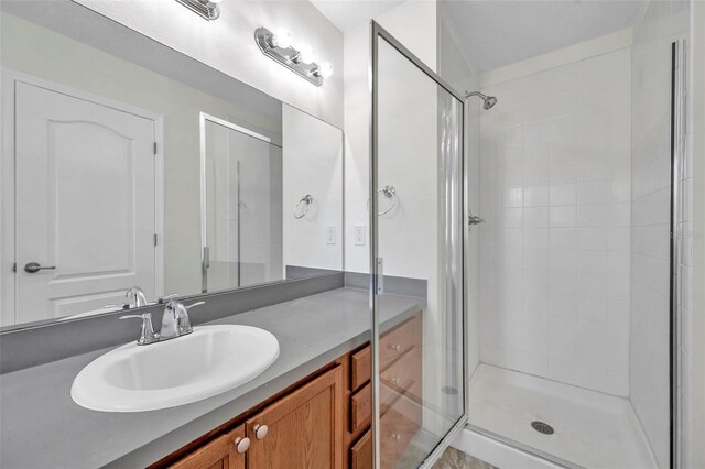bathroom featuring vanity and a stall shower