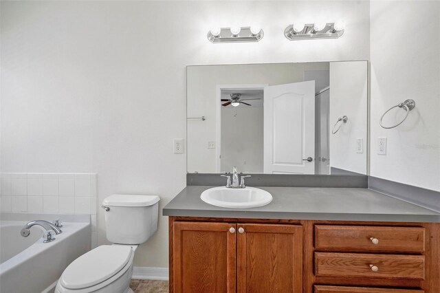 full bath featuring vanity, toilet, baseboards, a bath, and a ceiling fan