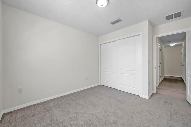 unfurnished bedroom with visible vents, baseboards, and carpet floors