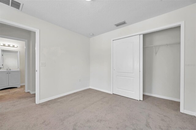 unfurnished bedroom with carpet and visible vents