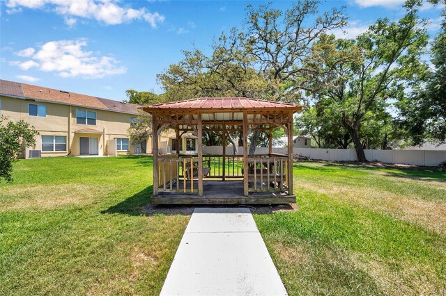 exterior space featuring a gazebo, fence, and central AC