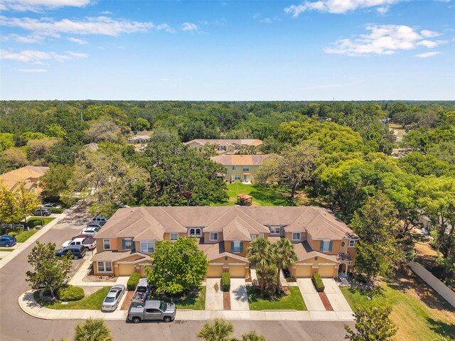 bird's eye view featuring a residential view and a wooded view