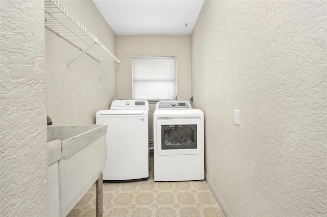 280 Fortaleza St, Punta Gorda, FL 33983 - clothes washing area featuring a textured wall, washing machine and dryer, and baseboards