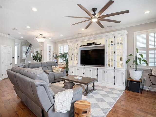 living area with stairway, ceiling fan with notable chandelier, recessed lighting, and visible vents
