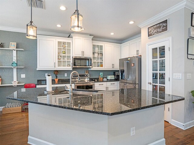 kitchen with appliances with stainless steel finishes, a sink, baseboards, dark wood-style floors, and ornamental molding