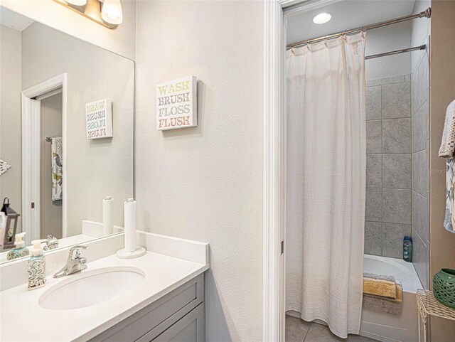 bathroom with vanity, tile patterned flooring, and shower / tub combo