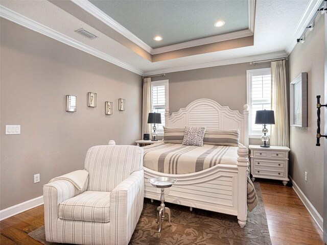 bedroom featuring crown molding, multiple windows, and dark wood finished floors