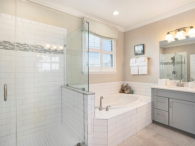 bathroom with crown molding, vanity, a bath, tile patterned floors, and a stall shower