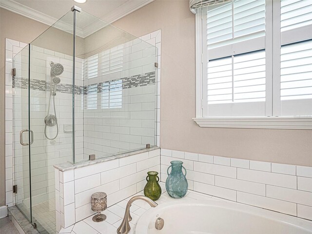 bathroom with crown molding, a shower stall, and a bath