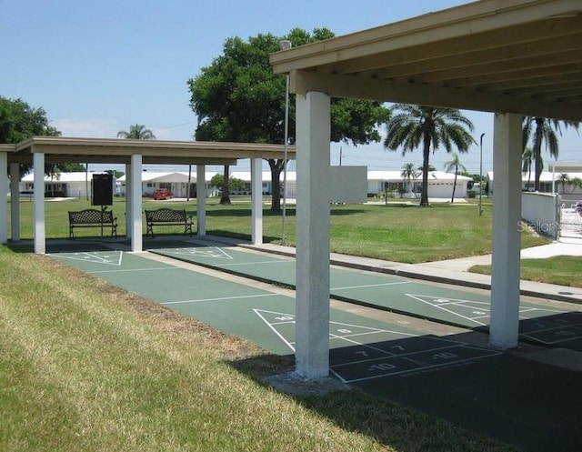view of home's community featuring a yard and shuffleboard