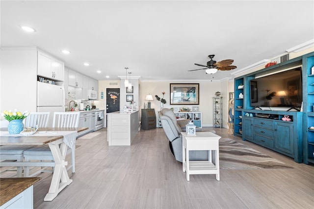 living room with recessed lighting, ornamental molding, and ceiling fan