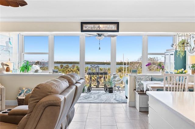sunroom featuring a healthy amount of sunlight and a water view