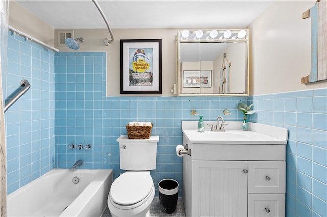 full bath featuring tile walls, washtub / shower combination, vanity, and toilet