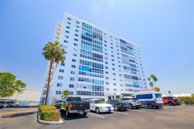 view of building exterior featuring uncovered parking